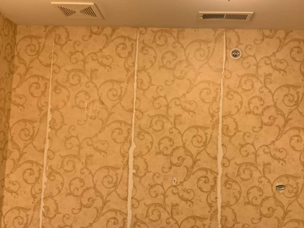 wallpaper beginning to peel from wall